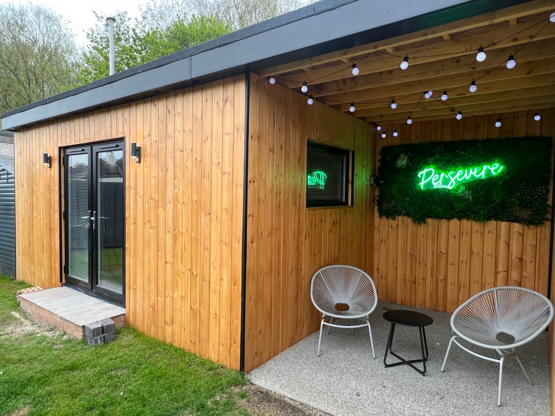 Premium garden room built by Alba Build Co. at dusk